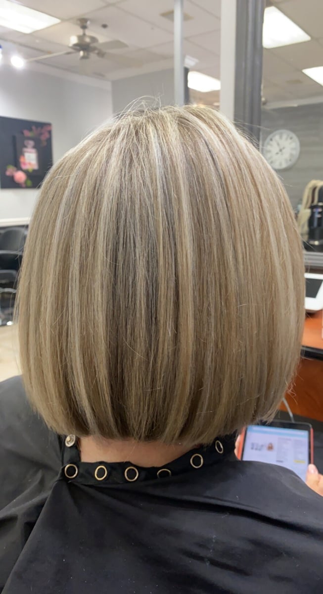 “Blonde bob haircut with sleek, straight styling and subtle highlights, showcasing a polished and professional salon finish.”